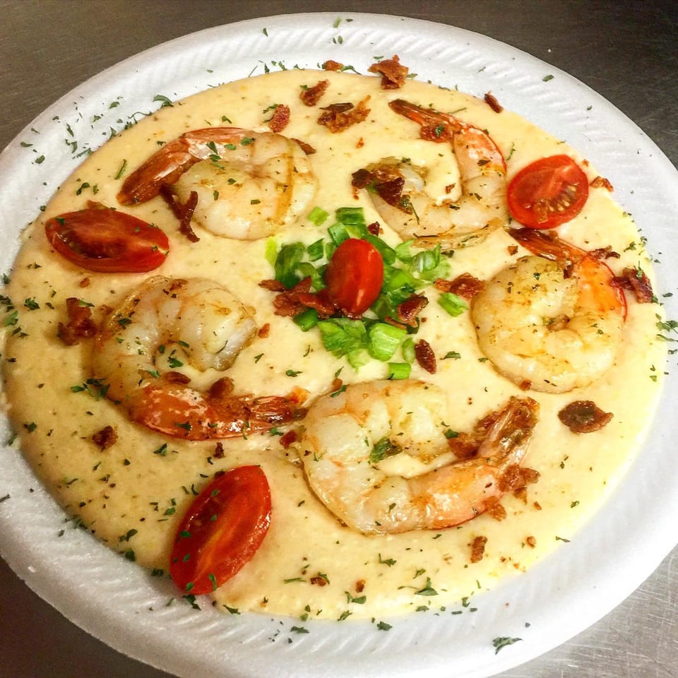 Fireman's Cafe shrimp and grits with cherry tomatoes, green onions, and bacon bits.